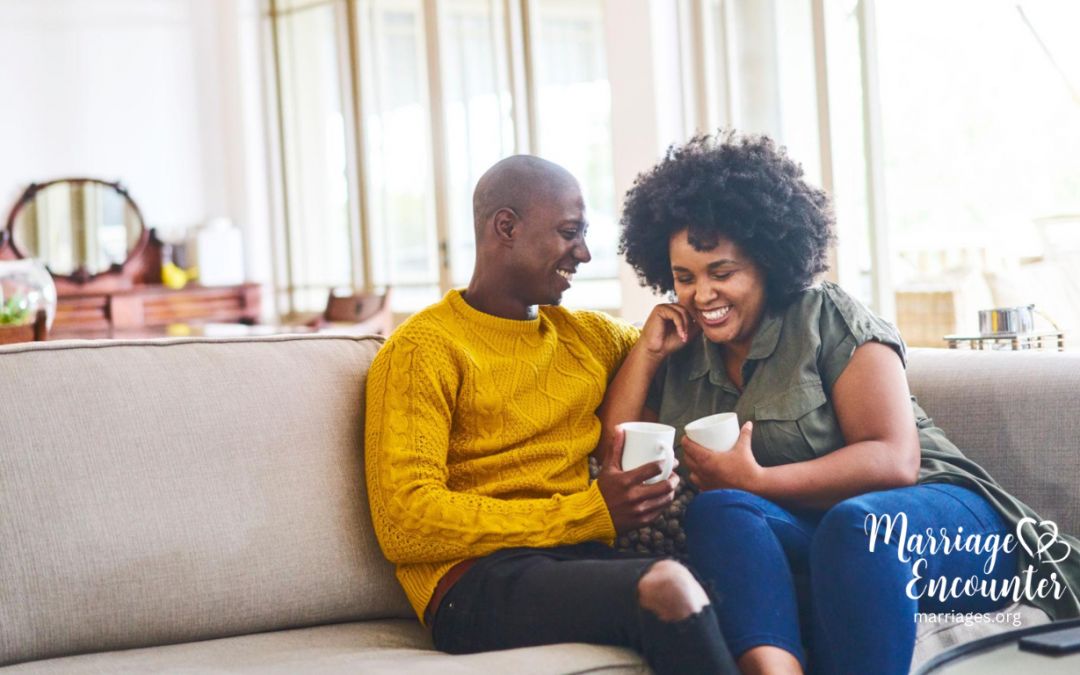 Married couple laughing together over coffee while reconnecting and strengthening their relationship through Marriage Encounter