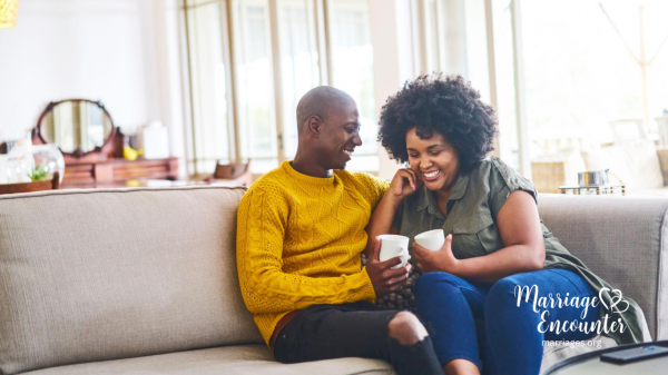 Married couple laughing together over coffee while reconnecting and strengthening their relationship through Marriage Encounter